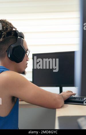 Computer programmer working at home, concentrating on the computer screen Stock Photo