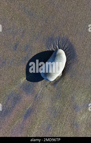 Patterns in sand after a winter storm and king tide, on the central coast of Oregon. Stock Photo