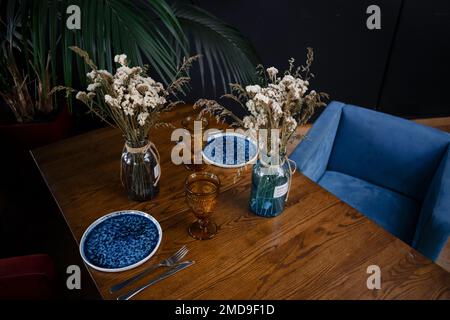 Simple table setting with flowers on dark background. High quality photo Stock Photo