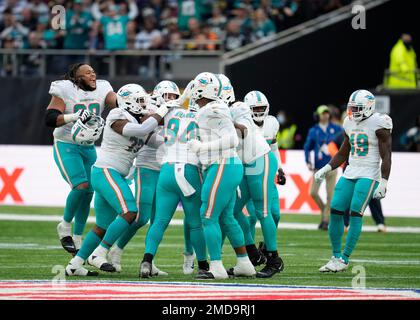 Miami Dolphins players celebrate after Miami Dolphins defensive end  Christian Wilkins (94) sacked Jacksonville Jaguars quarterback Trevor  Lawrence (16) during the second half of an NFL football game between the  Miami Dolphins and the Jacksonville