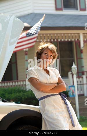 Pretty woman in a dress stranded with car trouble Stock Photo