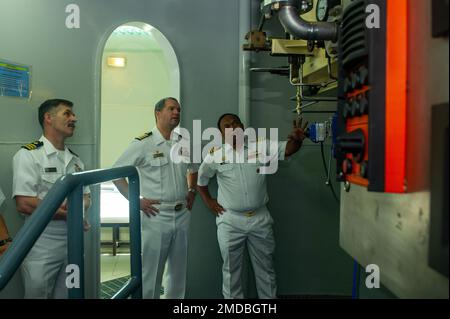 KOTA KINABALU, Malaysia (July 15, 2022) – Royal Malaysian Navy Capt. Kamalrulzaman bin Zainul, right, acting Submarine Force Commander and commanding officer of Submarine Training Centre, discusses the capabilities of a dive chamber with U.S. Navy Capt. John Frye, middle, commanding officer of the Emory S. Land-class submarine tender USS Frank Cable (AS 40), during a tour of the Submarine Command Headquarters on Sepanggar Naval Base in Kota Kinabalu, Malaysia, July 15, 2022. Frank Cable is currently on patrol conducting expeditionary maintenance and logistics in support of a free and open Indo Stock Photo