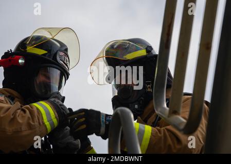 375th Civil Engineering Squadron firefighters communicate during a ...