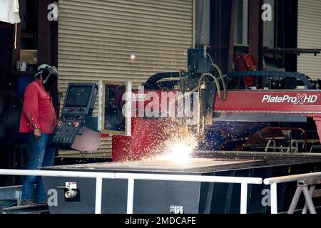 Michael Dunning Jr., a welder at the Army Corps of Engineers runs a PlateProX HD Large CNC Plasma/Oxy-fuel capable metal cutting machine, to cut out a 2 inch flange (donut) for the machinist to work on in the process of completing a off site project. Stock Photo