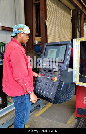 Michael Dunning Jr., a welder at the Army Corps of Engineers runs a PlateProX HD Large CNC Plasma/Oxy-fuel capable metal cutting machine, to cut out a 2 inch flange (donut) for the machinist to work on in the process of completing a off site project. Stock Photo