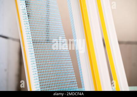 PVC window profile with a cuff and a blue mesh close-up on a blurred background Stock Photo