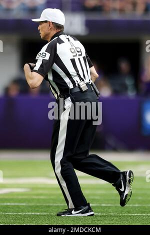 NFL umpire Dan Ferrell (64) on the field during an NFL football game  between the Cleveland Browns and Minnesota Vikings, Sunday, Oct. 3, 2021 in  Minneapolis. Cleveland won 14-7. (AP Photo/Stacy Bengs