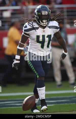 Seattle Seahawks' Alex Collins (41) runs a play during an NFL