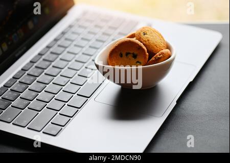 internet cookies internet browser cookies concept, mini cookies on keyboard computer laptop Stock Photo
