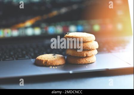 internet cookies internet browser cookies concept, mini cookies on keyboard computer laptop Stock Photo