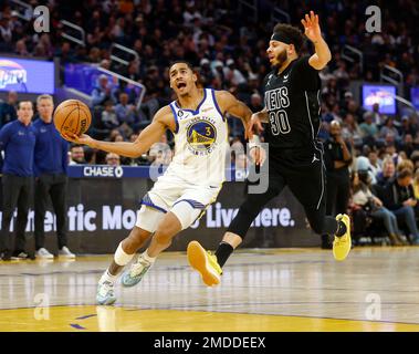 Golden State Warriors' Jordan Poole (3) reacts to San Francisco 49ers'  Deebo Samuel on the sideline after hitting a shot in the second half of an  NBA basketball game against the Memphis