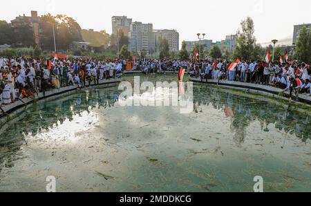 Irecha Oromos throw grass and flowers into a pool of water as they celebrate ...
