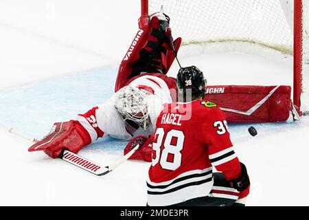 A shot by Chicago Blackhawks' Brandon Hagel (not shown) scores past New  Jersey Devils goaltender Jon Gillies (32) during the second period of an  NHL hockey game Friday, Feb. 25, 2022, in