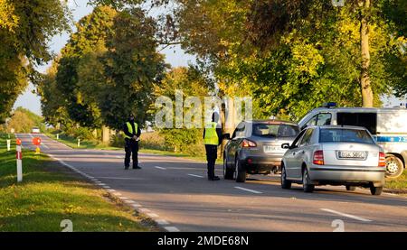 Polish police officers stop cars going in and out of an area along the  border with Belarus, where a state of emergency is in place, in Krynki,  Poland, Wednesday Sept. 29, 2021.