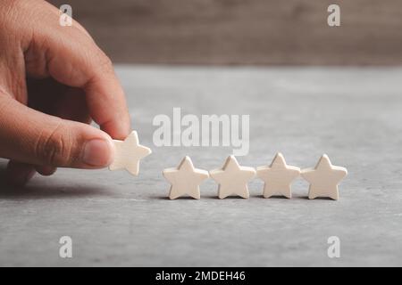 Hand picking stars.Customer experience, satisfaction survey, Evaluation, Increase rating and best excellent services rating concepts. Stock Photo