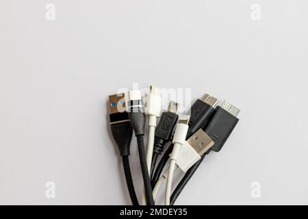 Mixed types of charging cables isolated on white background Stock Photo