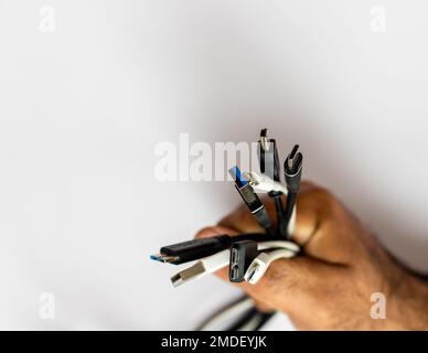 Holding various types of charging cables in hand Stock Photo