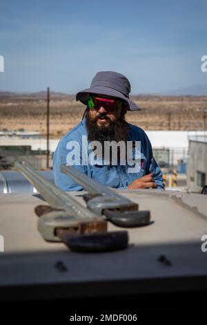 Bryan Anderson, a heating, ventilation, and air conditioning (HVAC) technician with Facilities Maintenance Branch, Public Works Division (PWD), Marine Corps Air Ground Combat Center (MCAGCC), operates on an air conditioning unit at MCGACC, Twentynine Palms, California, July 22, 2022. Despite the extreme heat of the high desert, the PWD, HVAC section maintains performance of air-cooling systems on buildings at the Combat Center. Stock Photo