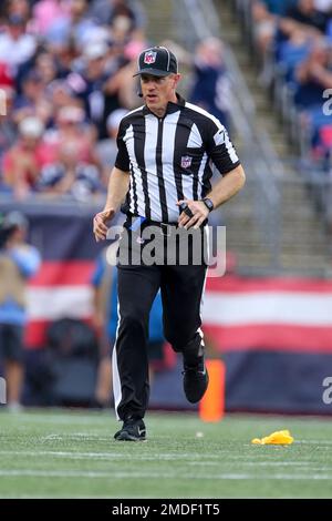 NFL umpire Alan Eck (76) carries the football down the field during an ...