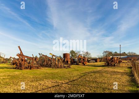 Shreveport, Louisiana - January 14, 2023: A cemetery of the old rustic pumpjacks in rural Louisiana Stock Photo