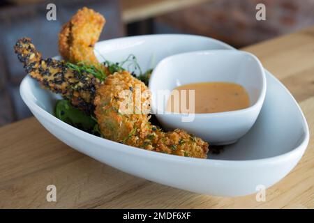 Sesame battered chicken wings with sauce Stock Photo
