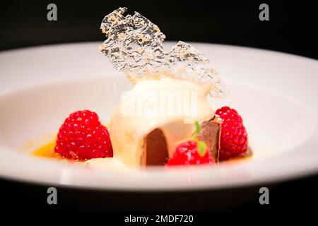 Vanilla ice cream with raspberries and caramelized sugar. Stock Photo