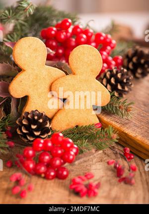 cookies in the shape of a man against the backdrop of the Christmas tree Stock Photo