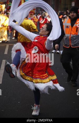 London UK, 22 January 2023. The Year of the Rabbit is celebrated in the  streets around London's China Town. A woman in red and white dances in the parade. Credit: Roland Ravenhill/Alamy Stock Photo