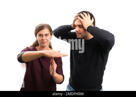 Cute adult woman model girlfriend making time out pause gesture using palms to shocked desperate boyfriend isolated on white background Stock Photo