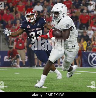 UNLV running back Charles Williams tries to get around Fresno State ...