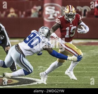 Dallas Cowboys wide receiver CeeDee Lamb (88) is tackled by San Francisco  49ers cornerback Jimmie Ward (1) during the first half of an NFL divisional  playoff football game in Santa Clara, Calif.