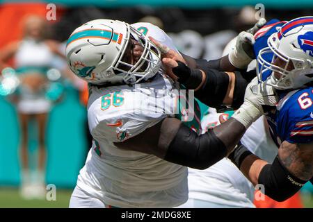 Miami Dolphins quarterback Jacoby Brissett (14) tries to hold off an attack  by Buffalo Bills defensive tackle Justin Zimmer (61) during the second half  of an NFL football game, Sunday, Sept. 19