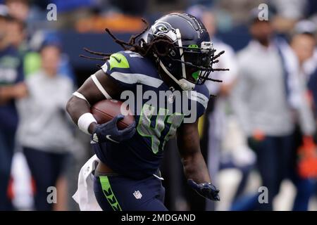 Seattle Seahawks running back Alex Collins is wrapped up by Los Angeles Rams  defensive tackle Sebastian Joseph-Day (69) as he rushes during the first  half of an NFL football game, Thursday, Oct.