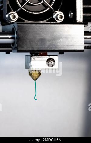 3D printer nozzle and green plastic close up Stock Photo