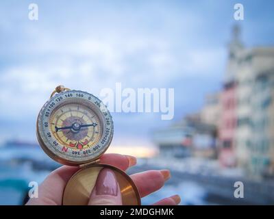 close up of golden compass in hand,streetb background . Stock Photo