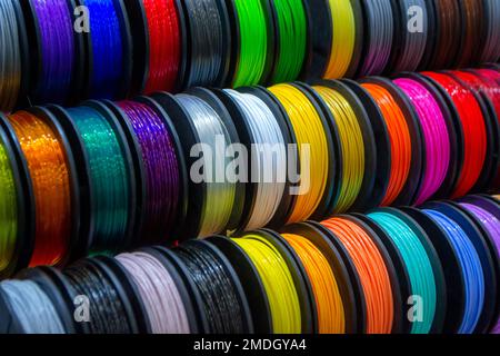 Many multi-colored spools of thread of filament for printing 3d printer. Material coils for printing 3D printer. Spools of 3D printing motley different colors filament. ABS wire plastic for 3d printer Stock Photo