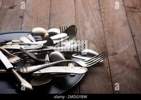 Metal cutlery on a wooden table Stock Photo