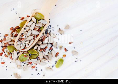 Seeds of goodness. A scoop of healthy seed mix on light wooden surface Stock Photo
