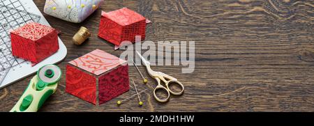 Diamonds stitched in the form of a cube. The process of sewing a quilt. Stock Photo