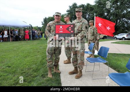 Outgoing Commanding General, Maj. Gen. Matthew V. Baker receives a gift from the unit upon the symbolic passing of the colors during a ceremony at the Veterans Memorial Park in Bartlett, Illinois, July 24. Stock Photo