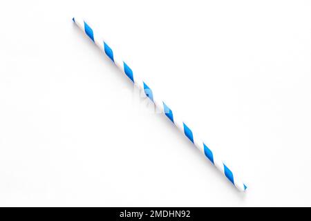 A single blue drinking straw with red and white stripes on white background. Stock Photo