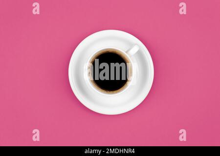 Cup of coffee and saucer on a pink background, flat lay. Stock Photo