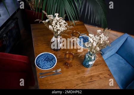 Easter table with spring flowers in a sunny April kitchen. High quality photo Stock Photo