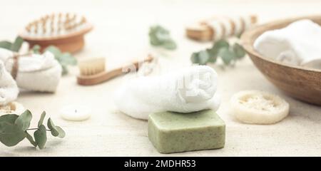 Spa composition with soap, brushes and towels on a blurred background. Stock Photo
