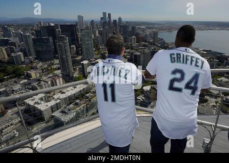Former Seattle Mariners players Edgar Martinez, left, and Ken Griffey Jr.,  right, look out over the Seattle skyline after they raised a flag for the  2023 MLB All-Star Game on the roof of the Space Needle, Thursday, Sept. 16,  2021, in Seattle. Earlier i