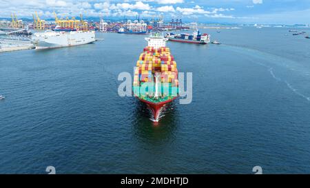 cargo maritime ship with contrail in the ocean ship carrying container and running for export concept technology freight shipping by ship smart servic Stock Photo