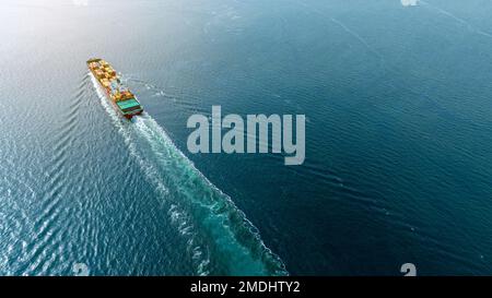 cargo maritime ship with contrail in the ocean ship carrying container and running for export concept technology freight shipping by ship smart servic Stock Photo