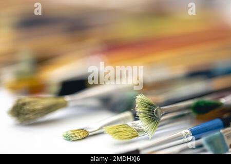 Paint brushes stained with paint, close-up, macro shot. Stock Photo