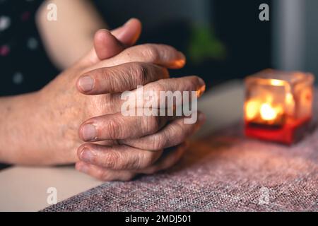 Hands of an old woman folded for prayer. Stock Photo