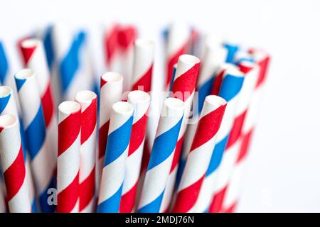 Multi-colored paper straws for drinks close-up on a white background. Stock Photo